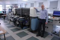 The new Atom 3 placement machine in the SMT line at Bitstream with CEO Dariusz Pietrzyk.